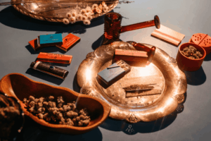 Blue dream strain: cannabis products arranged on metal plates and wooden trays 