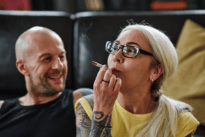 THC effects: Woman smoking cannabis with a man 